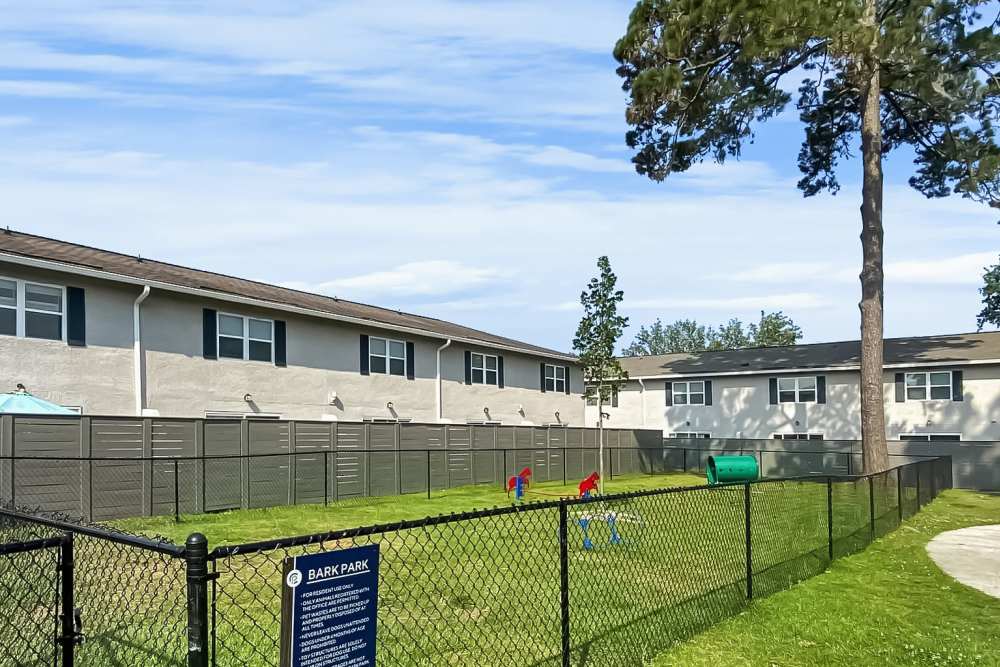 Spacious dog park with play equipment at Crescent Place in Savannah, Georgia