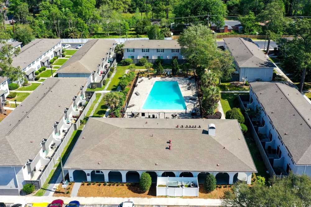 Sparkling pool surrounded by landscaped grounds at Crescent Place in Savannah, Georgia