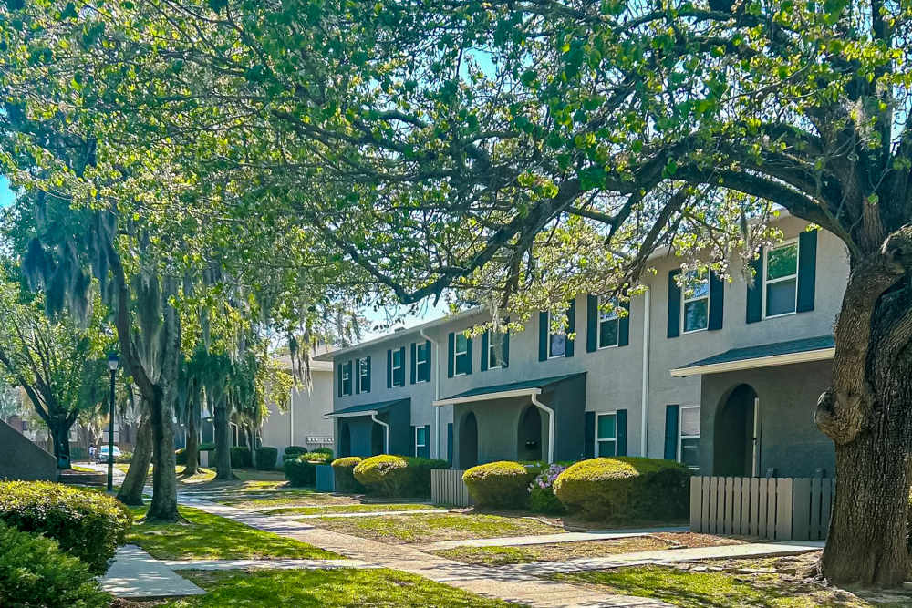 Tree-lined walkway with apartment buildings near Crescent Place in Savannah, Georgia