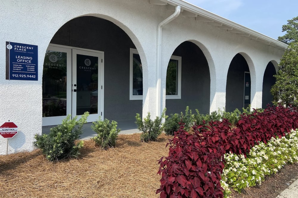 Leasing office entrance with landscaped garden at Crescent Place in Savannah, Georgia