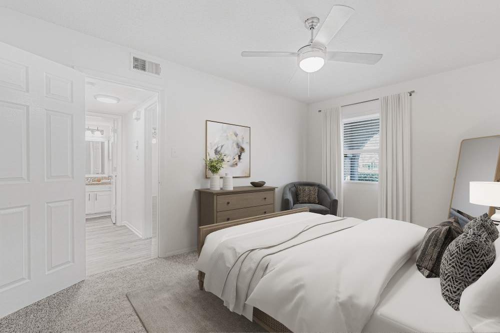 Bedroom with bed, dresser, and window at Crescent Place in Savannah, Georgia