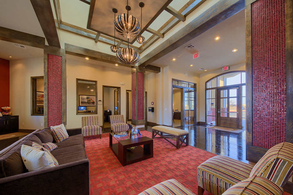 Red accent wall with seating area at Midway Station in Midland, Texas