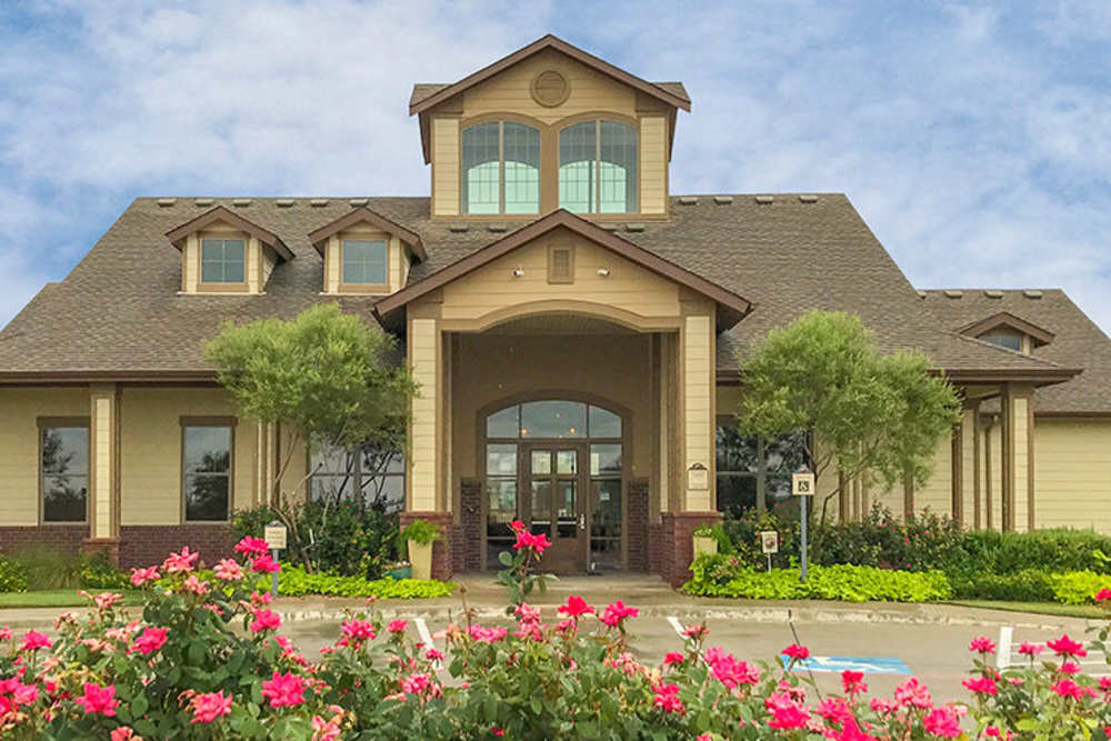 Flowers bloom in front of a building at Midway Station in Midland, Texas