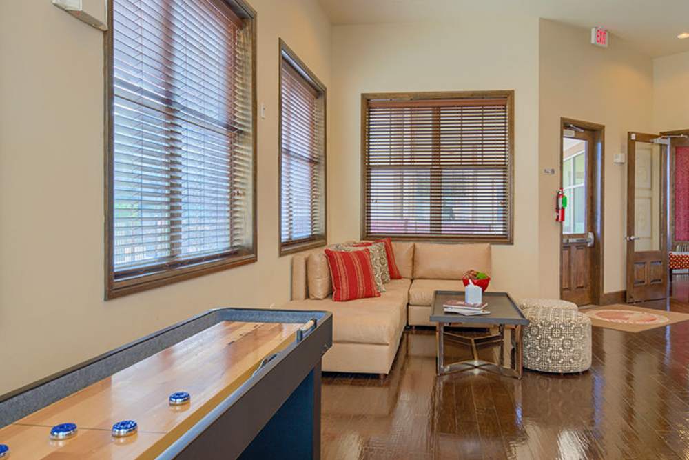 Playing shuffleboard in a lounge area at Midway Station in Midland, Texas