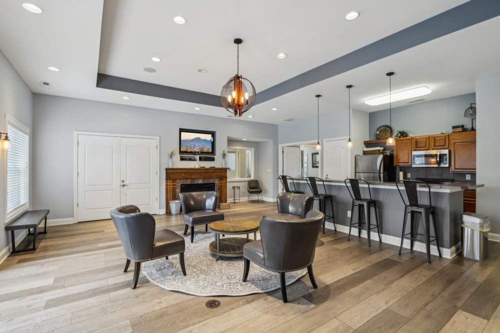 Spacious resident lounge with modern furnishings and entertainment area at Bluestone in Greenfield, Indiana