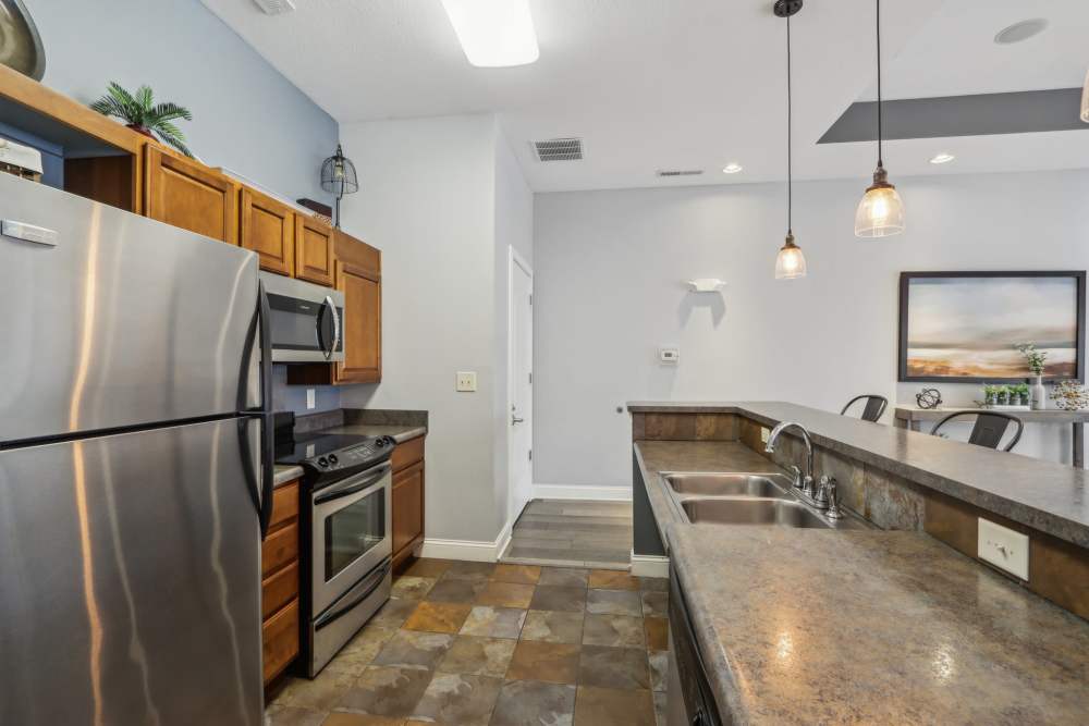 Apartment kitchen featuring stainless steel appliances and ample counter space at Bluestone in Greenfield, Indiana