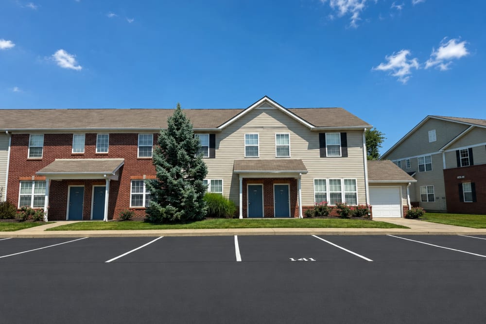 Bluestone apartment community exterior with parking and residential buildings at Bluestone in Greenfield, Indiana