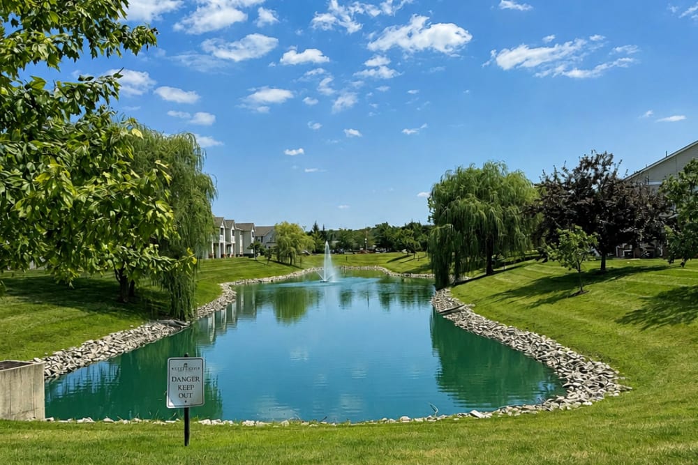 Outdoor recreational area overlooking landscaped pond at Bluestone in Greenfield, Indiana