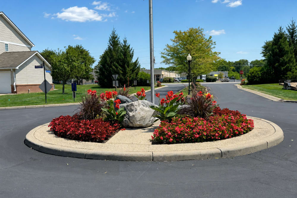 Apartment clubhouse exterior with manicured landscaping at Bluestone in Greenfield, Indiana