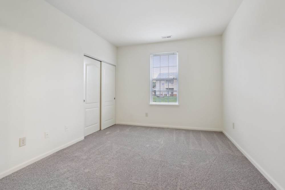 Bedroom featuring neutral decor and ample floor space at Bluestone in Greenfield, Indiana