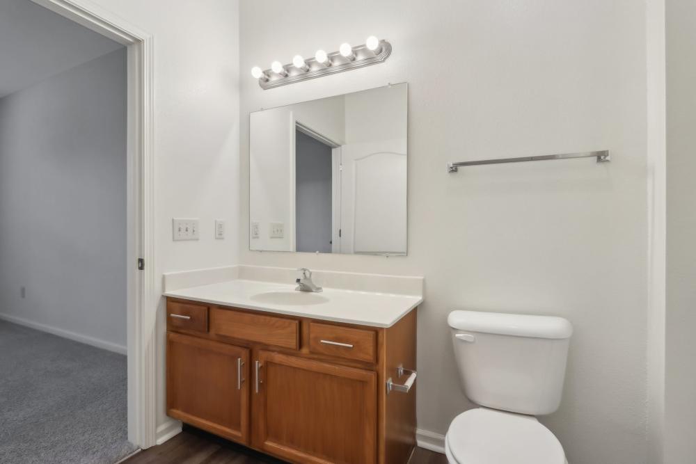 Modern bathroom with large mirror and countertop space at Bluestone in Greenfield, Indiana