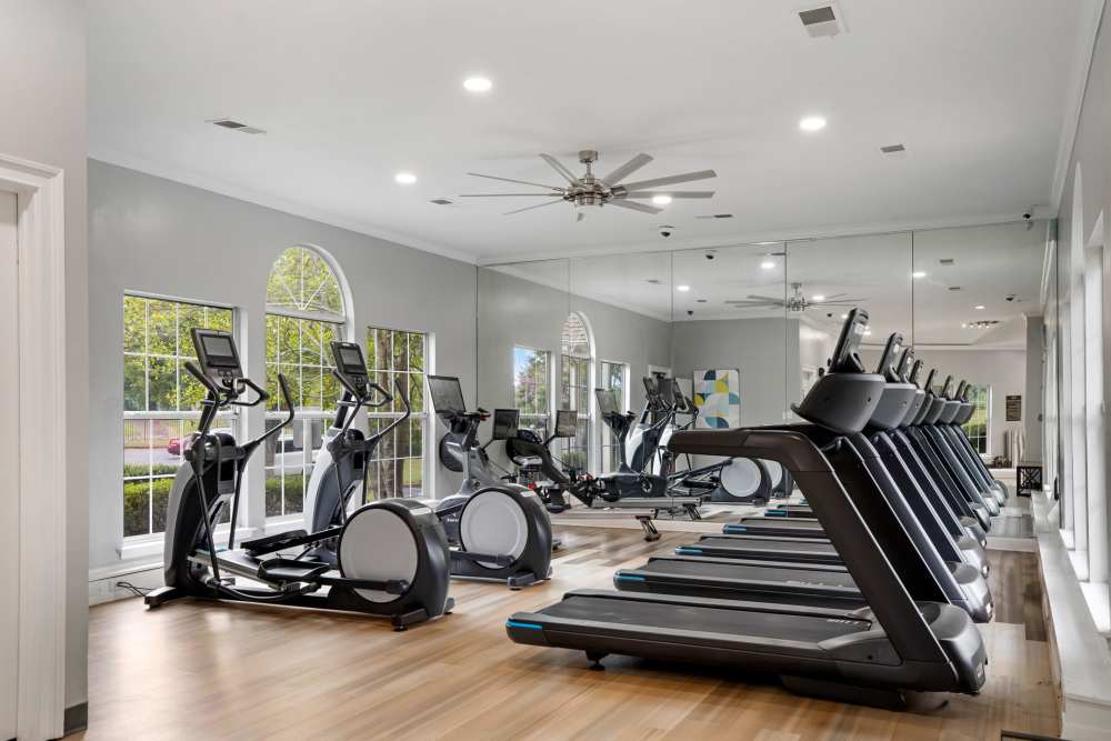 Fitness equipment lined against a mirrored wall at Stonebridge Crossing Apartment Homes in Cordova, Tennessee
