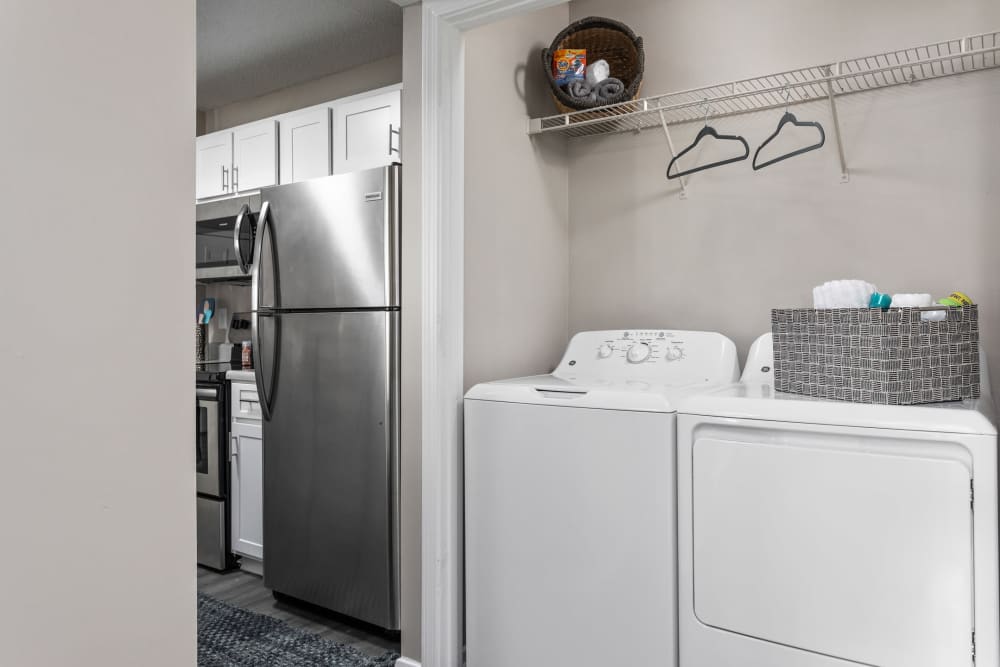Washer and dryer with storage shelf at Stonebridge Crossing Apartment Homes in Cordova, Tennessee