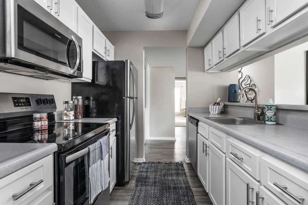 Black refrigerator and stainless steel appliances at Stonebridge Crossing Apartment Homes in Cordova, Tennessee