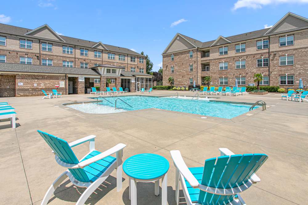 Resident relaxing with her feet in the pool at Keystone At Mebane Oaks in Mebane, North Carolina