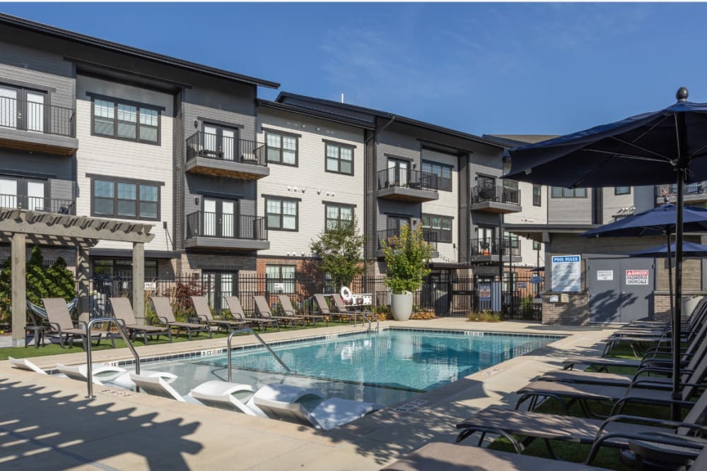 Swimming pool with sundeck and umbrellas at River Point West in Elkhart, Indiana