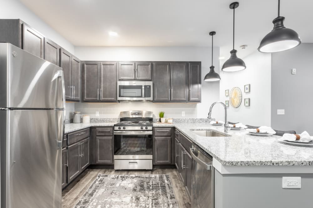Kitchen with stainless appliances and island at River Point West in Elkhart, Indiana