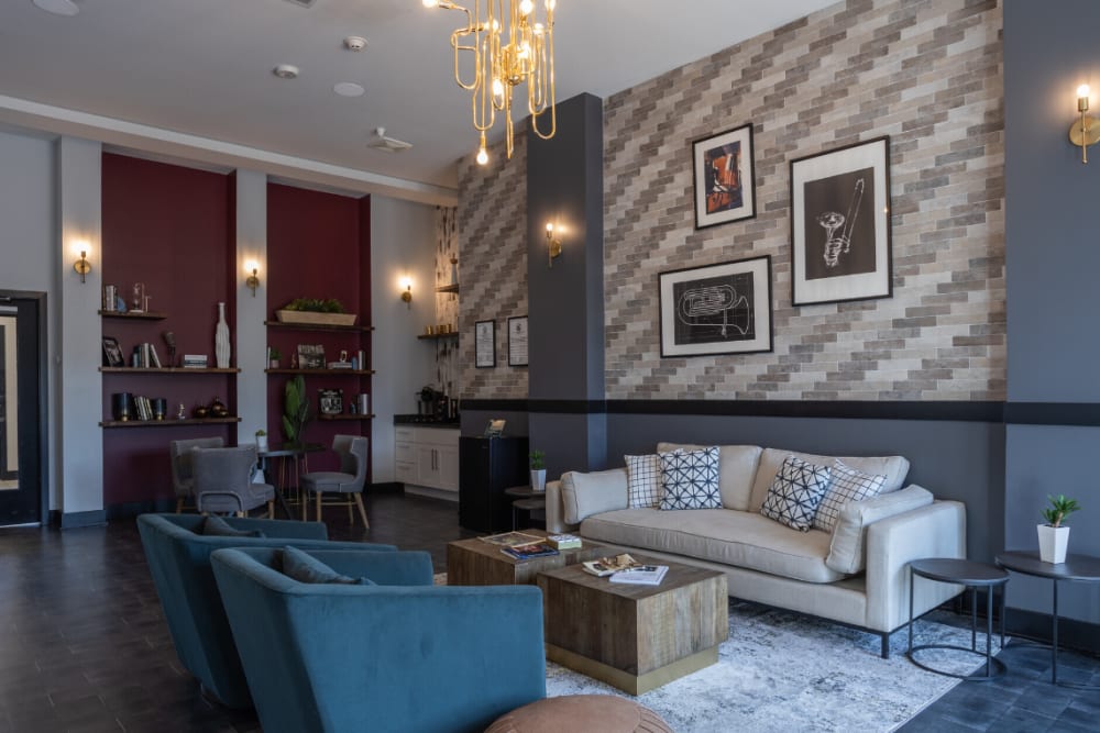 Clubhouse lounge with sofa and armchairs at River Point West in Elkhart, Indiana