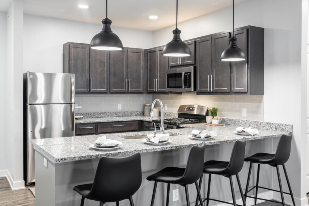 Kitchen breakfast bar with four stools at River Point West in Elkhart, Indiana