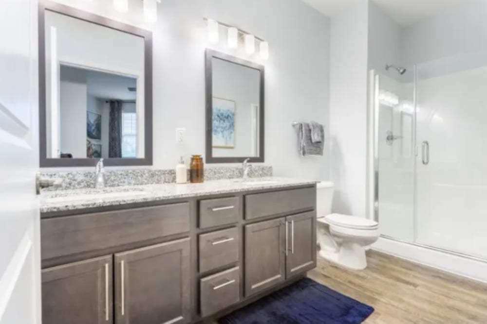 Bathroom with double vanity and shower at River Point West in Elkhart, Indiana