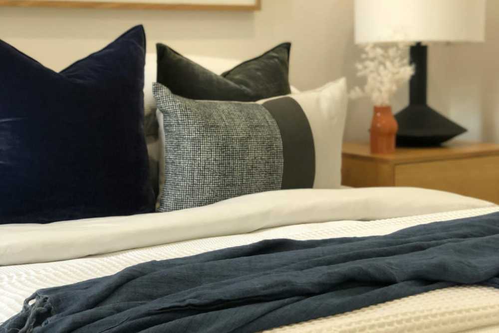 Decorative pillows on a bed with a throw at Crescent Place in Savannah, Georgia