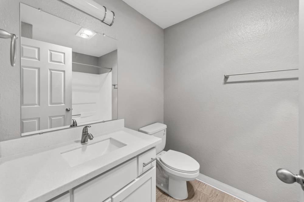 Bathroom with white vanity, toilet and shower at Fieldstone in Fairview, Oregon.