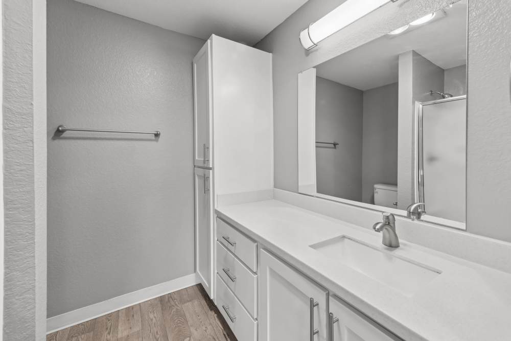 Bathroom with white vanity and linen cabinet at Fieldstone in Fairview, Oregon.