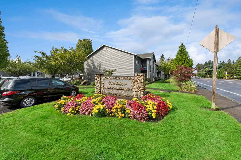Monument sign with flower bed at community entrance at Fieldstone in Fairview, Oregon.