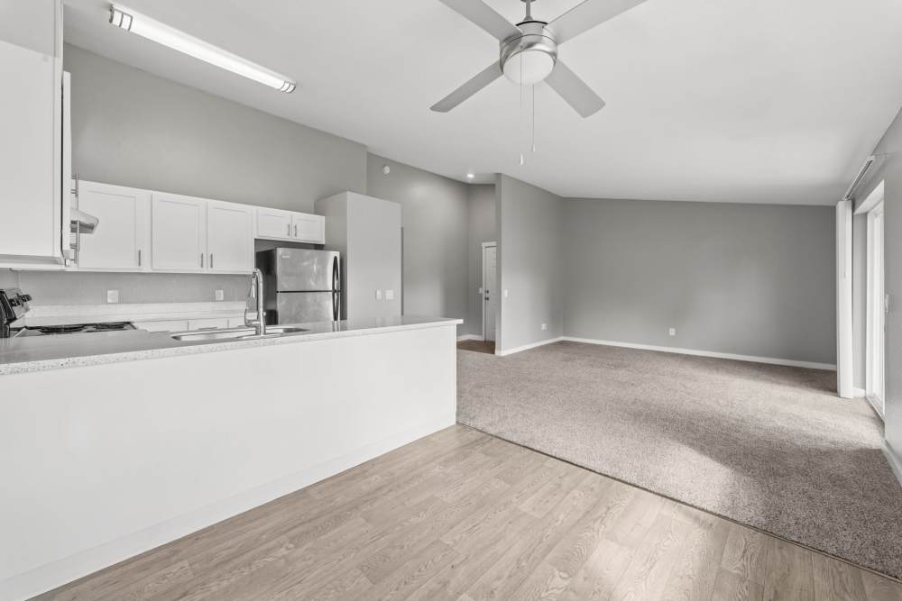 Open kitchen with white cabinets and peninsula counter at Fieldstone in Fairview, Oregon.