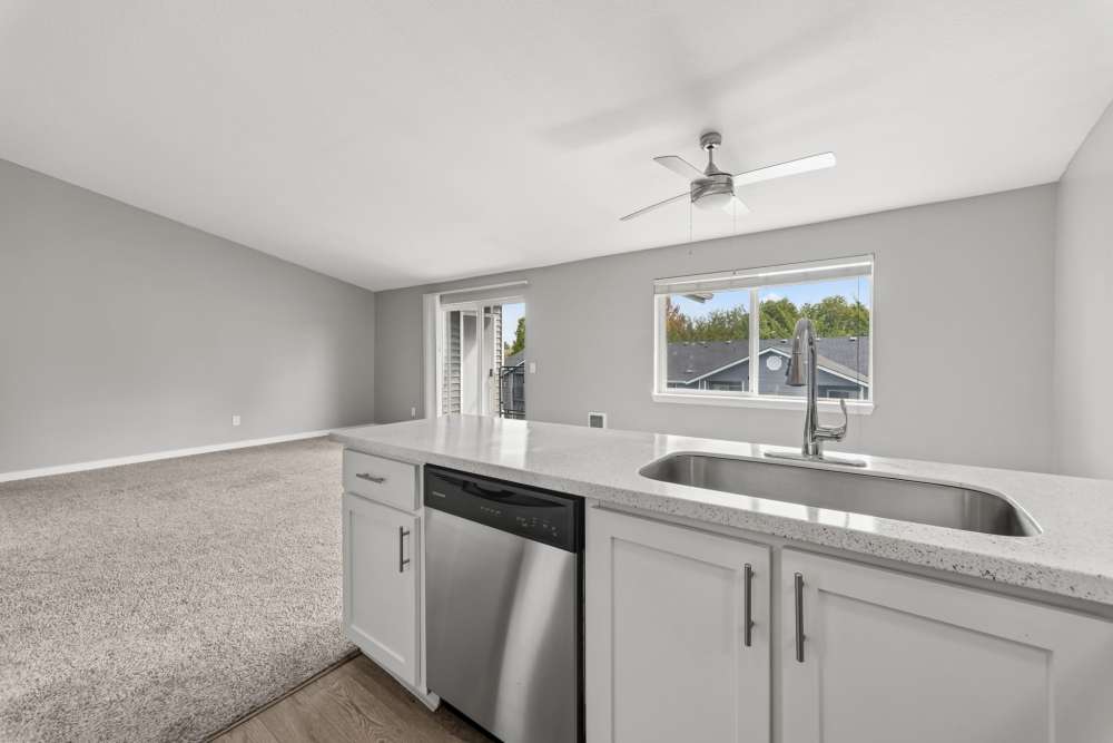Kitchen with sink and stainless steel dishwasher at Fieldstone in Fairview, Oregon.