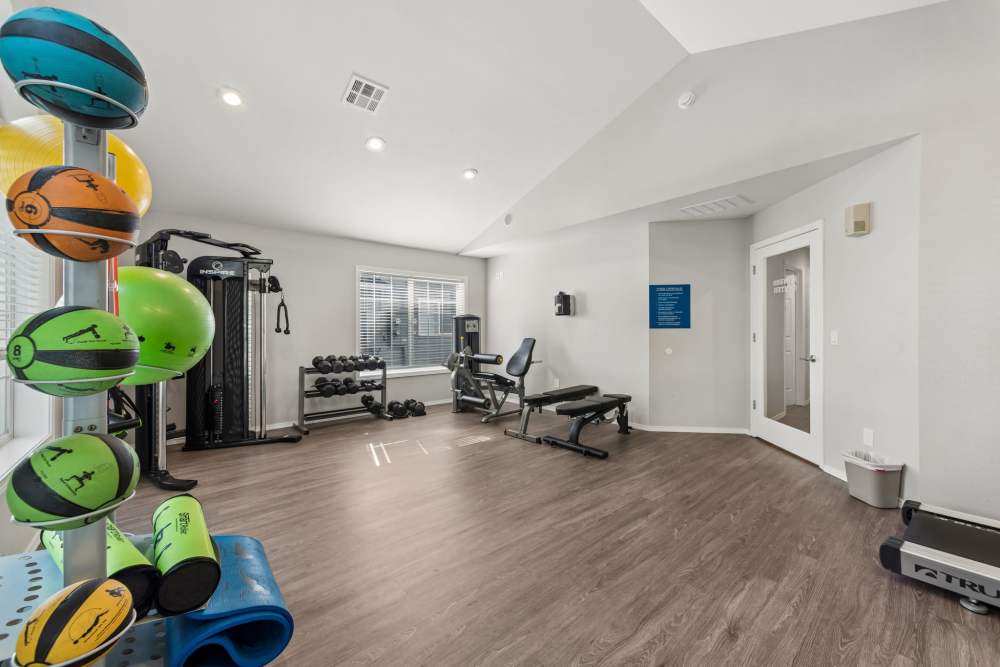 Fitness center with weight bench and exercise balls at Fieldstone in Fairview, Oregon.