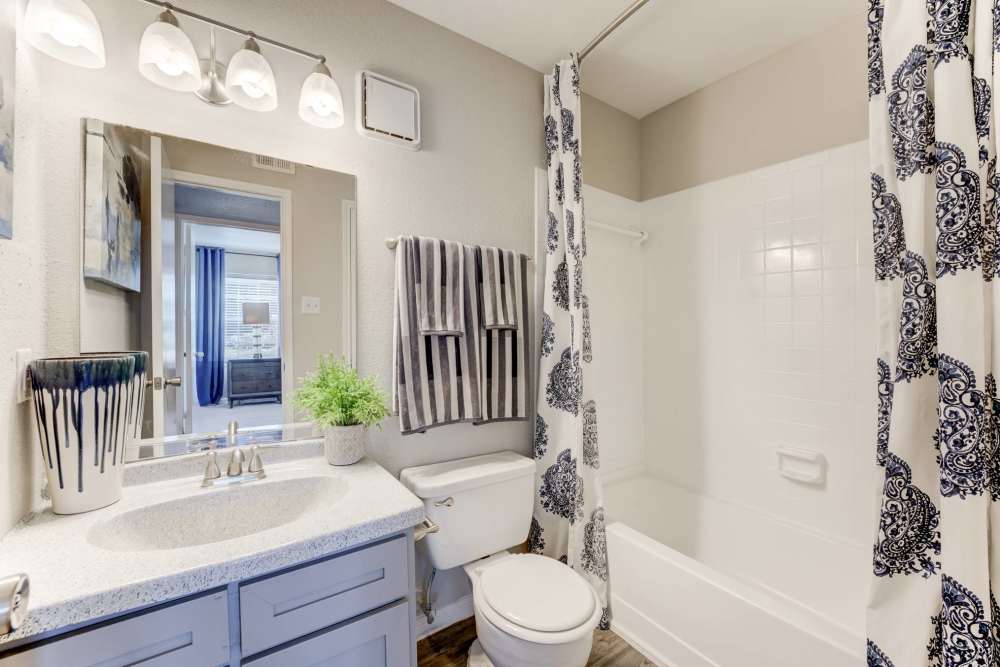 Bathroom with shower and tub combo at The Flats at Veranda Ridge in Texas City, Texas