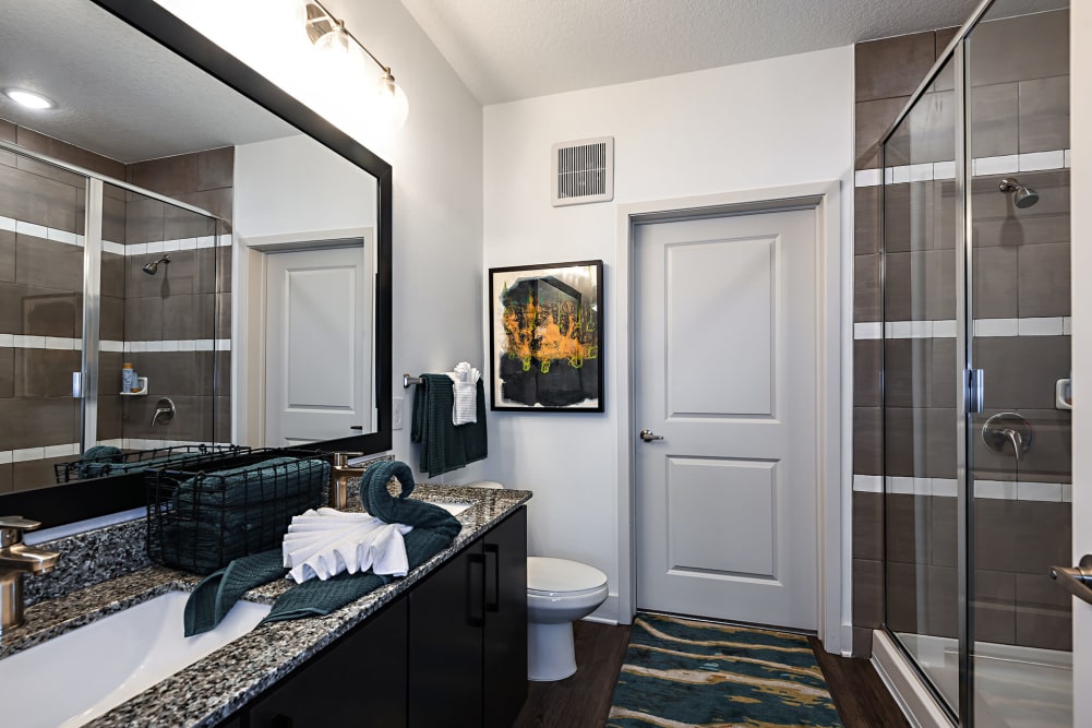 Bathroom with a glass shower at Olympus Preserve at Town Center in Jacksonville, Florida