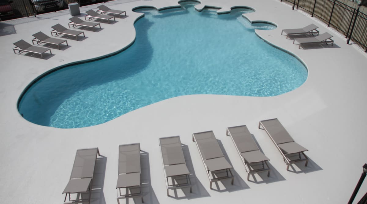 Resort-style pool surrounded by lounge chairs at The View Tower Apartments, Shreveport, Louisiana