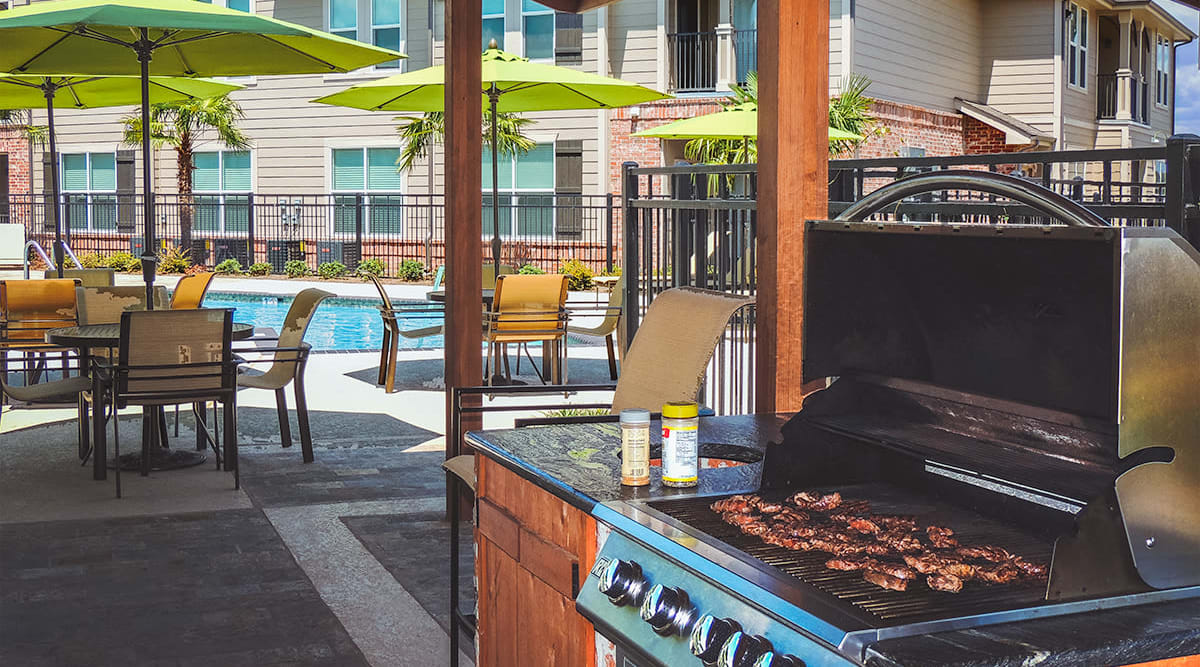 Barbeque at the poolside patio at Le Rivage Luxury Apartments in Bossier City, Louisiana