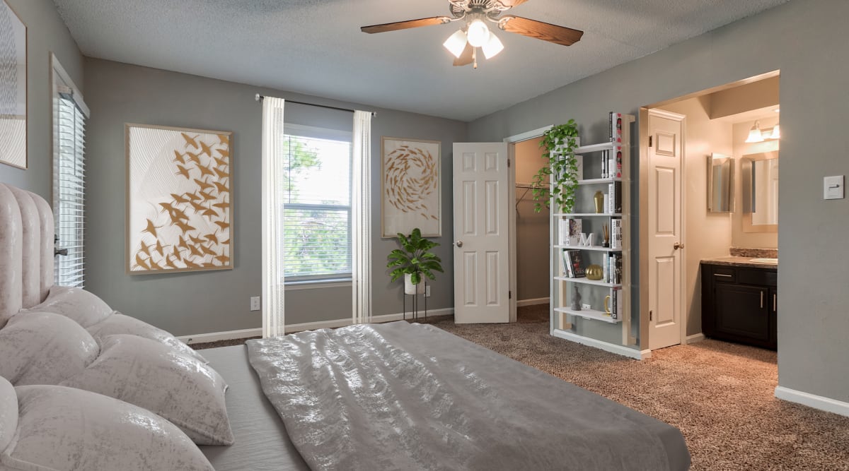Bedroom with plush carpeting at The Gatsby at Midtown Apartment Living in Montgomery, Alabama