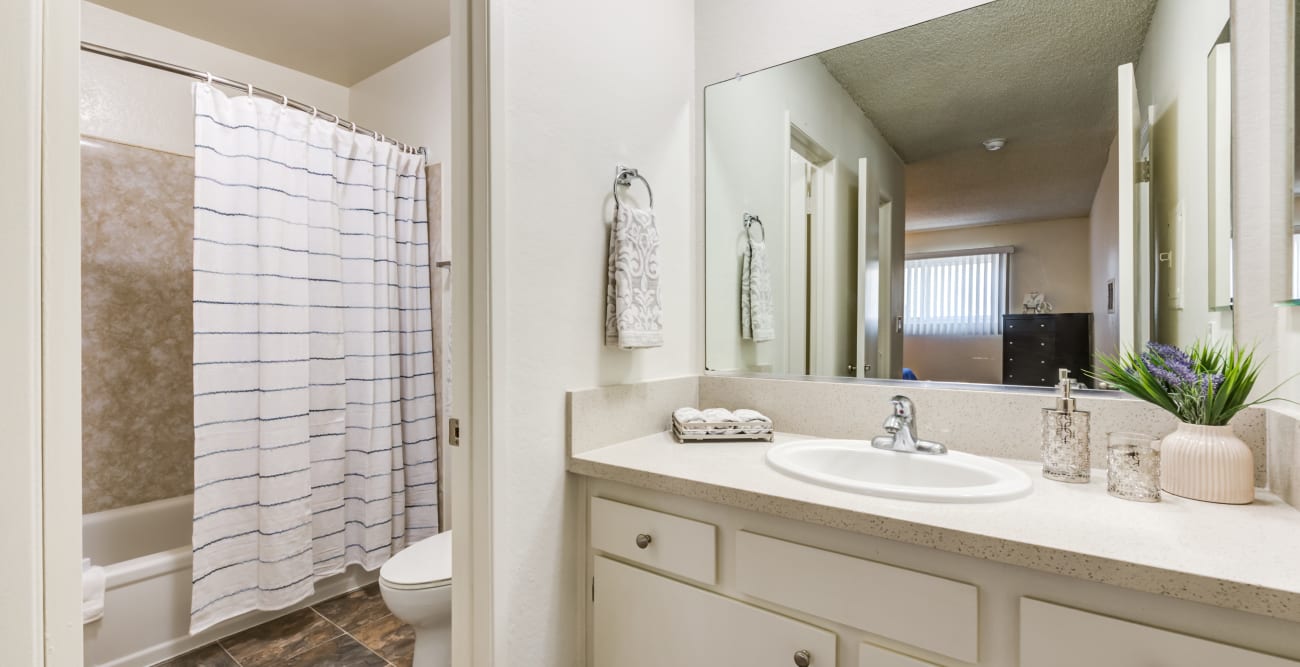 Bright bathroom with separate toilet and bathtub area at The Crossroads in Van Nuys, CA