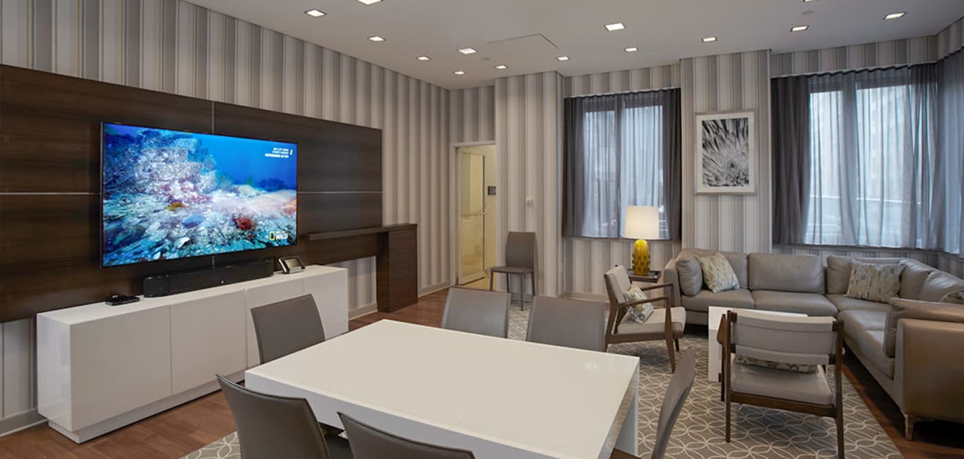 Lounge area with large tv for residents to hang out in at The Melar in New York, New York