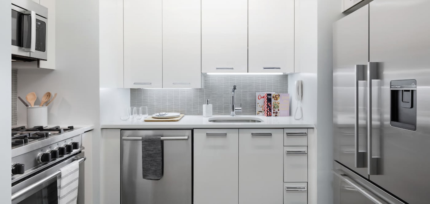 Modern kitchen with sleek appliances in a model studio apartment at The Melar in New York, New York