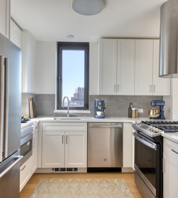 Spacious kitchen with stainless-steel appliances in a model home at 301 E 94th Street in New York, New York