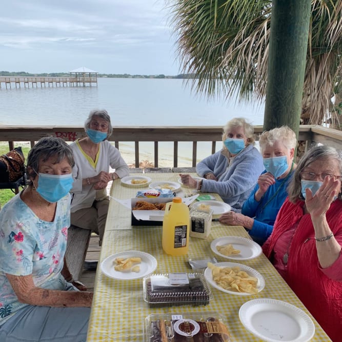 residents enjoying a meal by the water