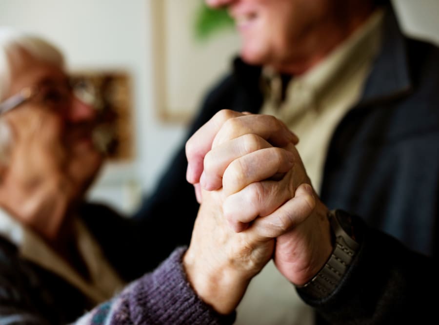 Two residents holding hands at Regency Palms Oxnard in Oxnard, California