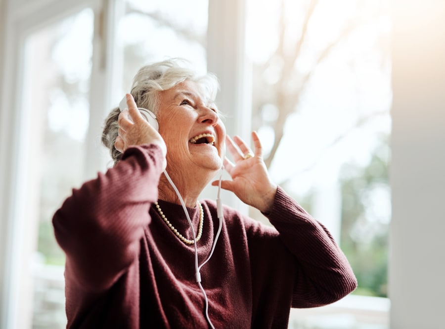 Resident listening to music at Regency Palms Long Beach in Long Beach, California