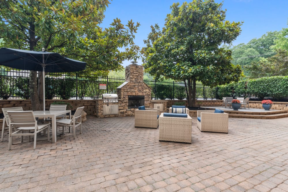 A ground-level patio with a fireplace at Goldelm at 414 Flats in Knoxville, Tennessee