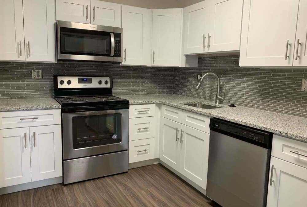 Modern kitchen with white cabinetry and stainless-steel appliances at Nieuw Amsterdam Apartment Homes in Marlton, NJ