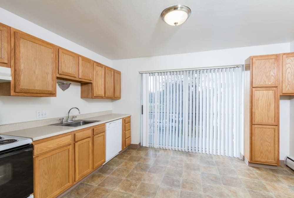 Spacious, well-lit kitchen at Pittsford Garden Apartments in Pittsford, New York