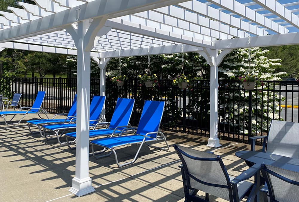 Poolside pergola with lounge seating at Imperial Gardens Apartment Homes in Middletown, NY