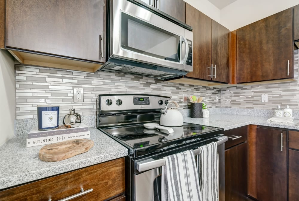 Contemporary kitchen with stainless-steel appliances at Torrente Apartment Homes in Upper St Clair, Pennsylvania