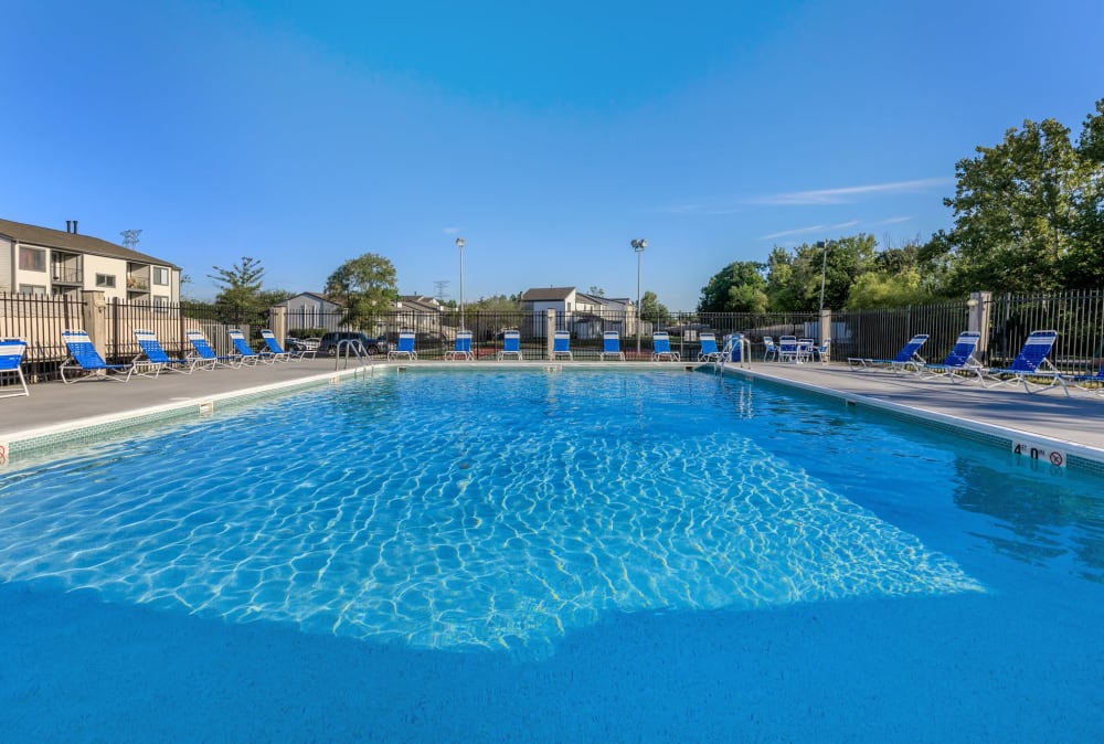 Sparkling swimming pool and poolside lounge chairs at Lakeside Crossing at Eagle Creek in Indianapolis, Indiana