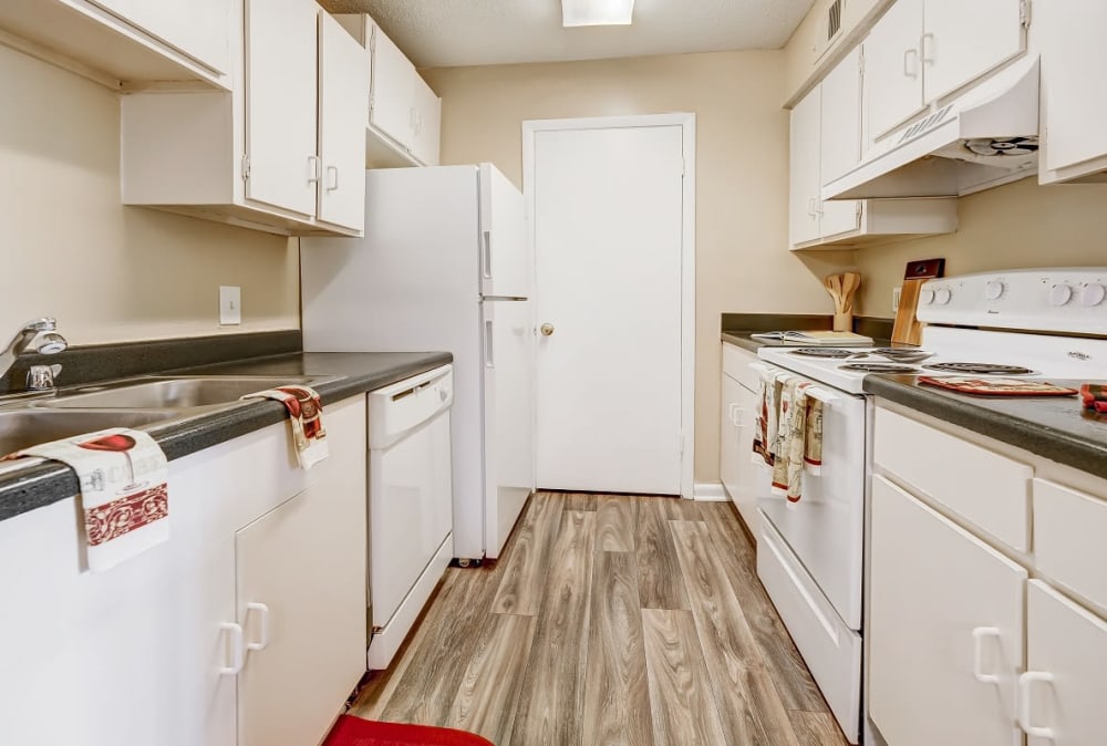 Kitchen with white cabinets and appliances at Forestbrook Apartments & Townhomes in West Columbia, South Carolina